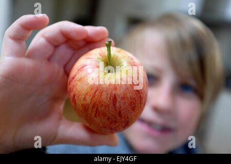 a child holding an apple Stock Photo