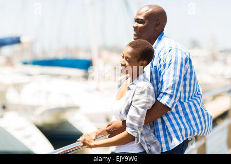 cute young African American couple daydreaming at the harbor Stock Photo