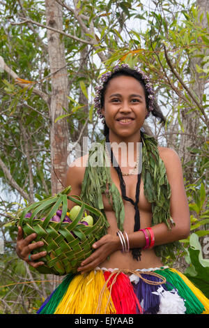 Yapese girl carrying basket of fruit, Yap Island, Federated States of Micronesia Stock Photo
