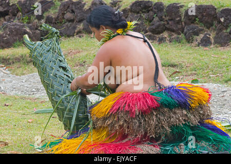 Yapese woman in traditional clothing weaving hand bag with palm tree leaves at Yap Day Festival, Yap Island, Federated States of Stock Photo