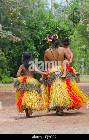 Yapese woman in traditional clothing carrying little girl at Yap Day Festival, Yap Island, Federated States of Micronesia Stock Photo