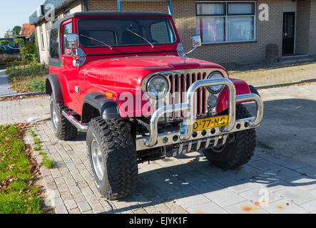 red jeep wrangler car with chrome bull bar. The production of the Wrangler began in 1987 and was succeeded in 1997 and 2007 by a Stock Photo