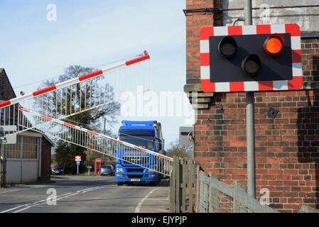 lorry driver waiting as barriers open at Howden station level crossing united kingdom Stock Photo