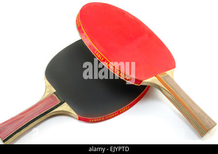 Two table tennis rackets one on top of the other isolated on white. One paddle is red and the other is black Stock Photo