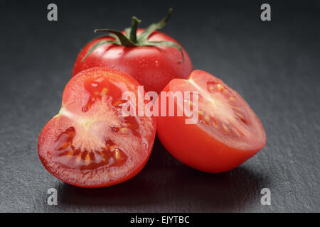 ripe washed tomatoes on slate background Stock Photo