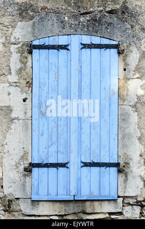 Bright blue window shutters on an old stone house, Santenay, Côte-dOr, France Stock Photo