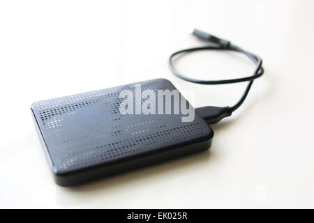 Portable external hard disk drive with USB cable on white background Stock Photo