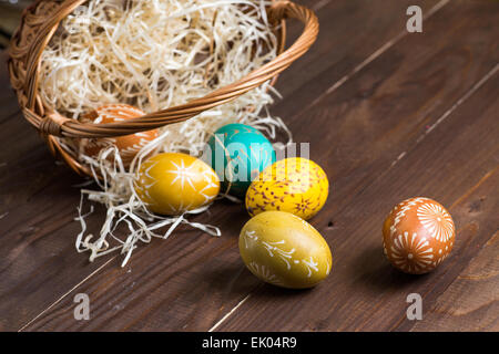 Easter eggs falling out from brown basket Stock Photo