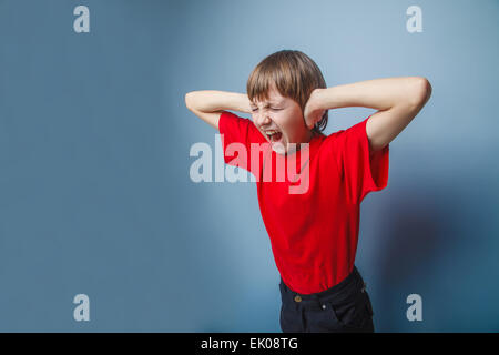 teenager boy brown European appearance in a red shirt covered hi Stock Photo