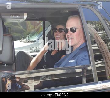 Neal McDonough kisses his wife Ruvé Robertson, in the back seat of his