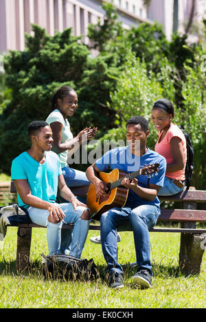 group of cheerful African American college friends having fun on campus Stock Photo