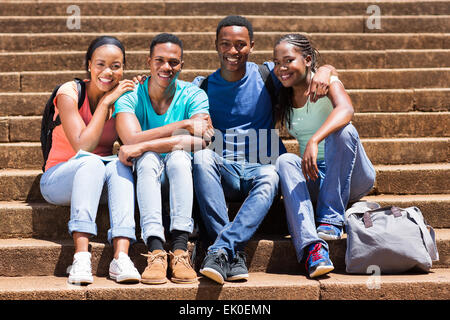 group of beautiful African university students sitting on steps Stock Photo