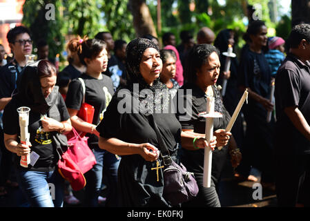 Larantuka, Indonesia. 3rd April, 2015. People walk in a devotional march to bring an old Mother Mary statue to Cathedral Church in Larantuka, Flores Island, Indonesia. Thousands of people, including those from other cities and countries, attend a whole week ceremonies to celebrate Holy Week in the small town of Larantuka, one of the most influential cities in Indonesia in terms of Roman Catholic traditions. Strongly influenced by the Portuguese since the 16 century, Catholic rituals in Larantuka have grown in smooth acculturation with local cultures. Stock Photo