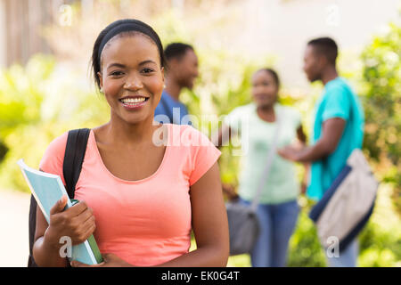 beautiful female college student holding books Stock Photo