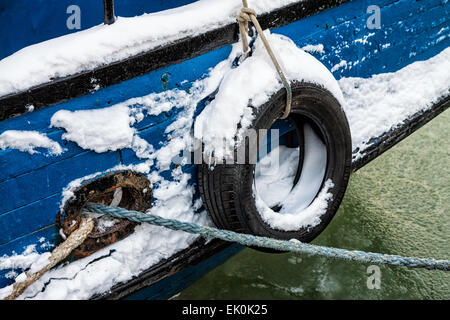 Fender on a fishing boat in a port in winter Stock Photo