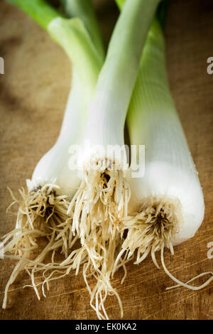 Bunch of spring onions on wood background Stock Photo