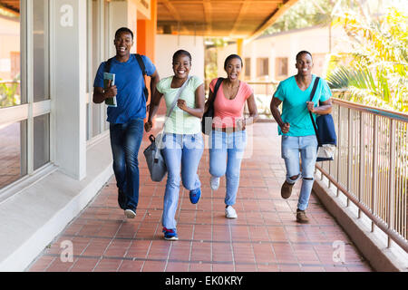 cheerful African college students running to lecture hall Stock Photo