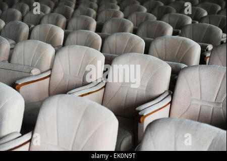 Rows with lots of empty beige velvet armchairs in a big conference room Stock Photo