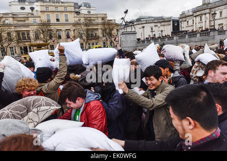 London, UK. 4th April, 2015. In Trafalgar Square thousands of pillow fighters battered each other until the feathers flew for International Pillow Fight Day. The display of pillow pulverising was spectacular with everyone eager to display their fighting prowess with feather and sponge filled pillows.  Alamy Live News/Photographer Credit:  Gordon Scammell Stock Photo
