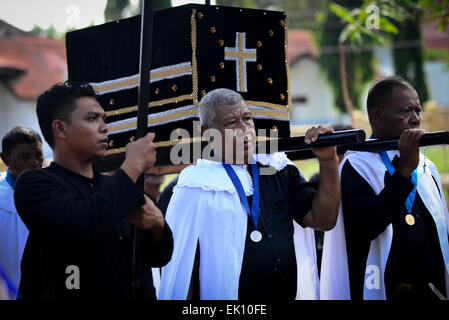 Men in procession to haul 'Tuan Ma', an old small wooden box containing  secret holy thing in Larantuka, Flores Island, Indonesia. Thousands of people, including those from other cities and countries, attend a whole week ceremonies to celebrate Holy Week in the small town of Larantuka, one of the most influential cities in Indonesia in terms of Roman Catholic traditions. Stock Photo