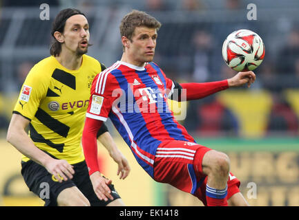 Dortmund, Germany. 4th Apr, 2015. Dortmund's Neven Subotic (l) and Munich'S Thomas Mueller (r) compete for the ball during the German Bundesliga soccer match between Borussia Dortmund and Bayern Munich at the Signal-Iduna-Park in Dortmund, Germany, 4 April 2015. PHOTO: FRISO GENTSCH/dpa EMBARGO CONDITIONS - ATTENTION: Due to the accreditation guidelines, the DFL only permits the publication and utilisation of up to 15 pictures per match on the internet and in online media during the match.) Credit:  dpa/Alamy Live News Stock Photo