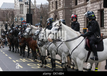 Whitehall, London, April 4th 2015. As PEGIDA UK holds a poorly attended rally on Whitehall, scores of police are called in to contain counter protesters from various London anti-fascist movements. PICTURED: Mounted police officers wait to be called in to support police lines in Whitehall as scuffles further up the road continue. Credit:  Paul Davey/Alamy Live News Stock Photo
