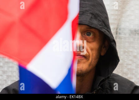 Whitehall, London, April 4th 2015. As PEGIDA UK holds a poorly attended rally on Whitehall, scores of police are called in to contain counter protesters from various London anti-fascist movements. PICTURED: One of the few PEGIDA supporters waits for their rally to begin. Credit:  Paul Davey/Alamy Live News Stock Photo
