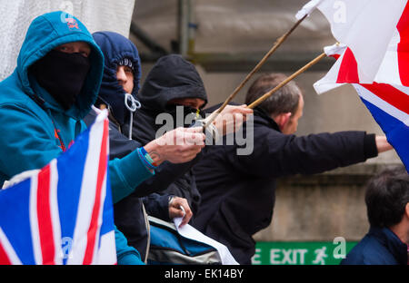 Whitehall, London, April 4th 2015. As PEGIDA UK holds a poorly attended rally on Whitehall, scores of police are called in to contain counter protesters from various London anti-fascist movements. PICTURED: PEGIDA supporters wait for their rally to begin Credit:  Paul Davey/Alamy Live News Stock Photo
