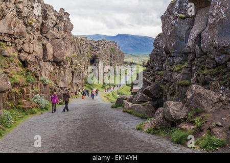 Walking through the cliffs in Thingvellir National Park in Iceland Stock Photo