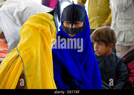 Bedu (Bedouin) women and boy at animal market in Sinaw, Oman Stock Photo