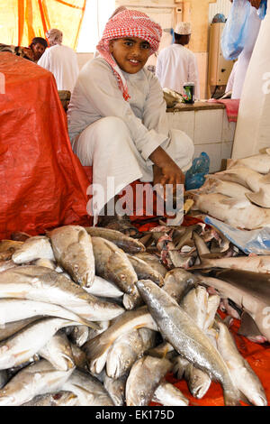 Boy selling fish in market, Sinaw, Oman Stock Photo