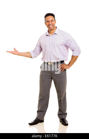 friendly middle aged businessman doing welcome gesture on white background Stock Photo