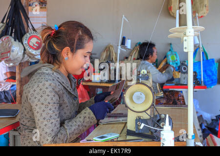 Young Cambodian girl working at sewing machine Stock Photo