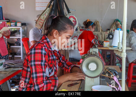 Young cambodian girl working at sewing machine Stock Photo