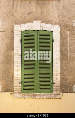 An arched window with closed green shutters, Santenay, Côte-dOr, France Stock Photo