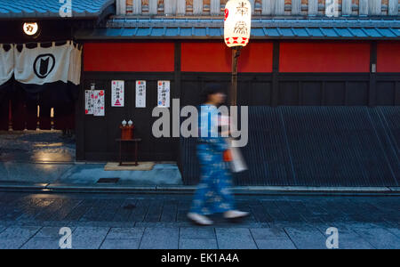 Woman in kimono walking on the narrow lane in Gion District, Kyoto, Japan Stock Photo