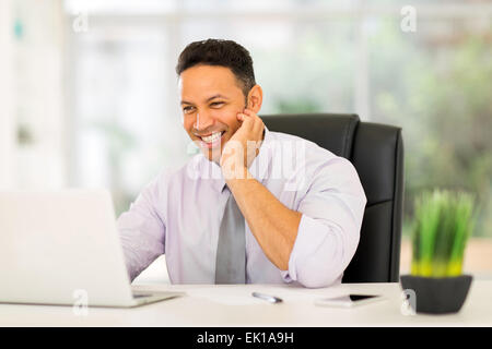 happy middle aged businessman working on laptop Stock Photo