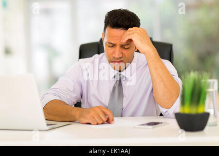 stressed businessman having headache at work Stock Photo