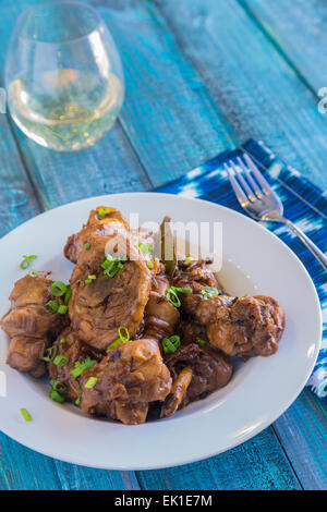 Chicken thighs marinated and cooked in adobo sauce Stock Photo