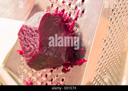 Cooking beet salad. Boiled beets on a grater Stock Photo