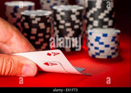 poker game. man's hand with a pair of aces Stock Photo