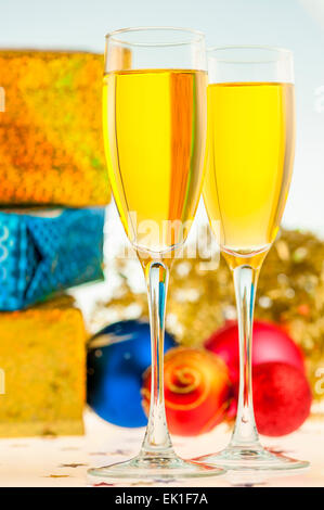 Glasses of champagne and christmas gifts on silver background Stock ...