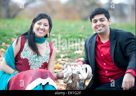 Young Happy Indian Couple Posing With Elephant Stock Photo