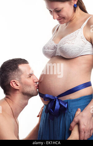 Happy father kissing the belly at his wife Stock Photo