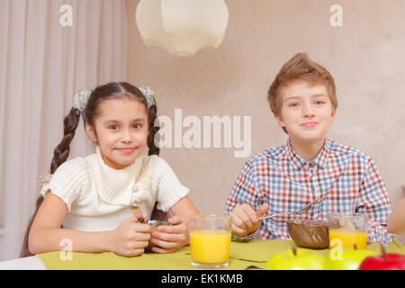 Cute kids have a meal at home Stock Photo