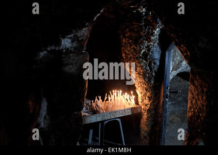 Candles lit inside the so-called Tomb of Joseph of Arimathea an anonymous rock-cut burial cave inside the Syriac Orthodox Chapel of Saint Joseph of Arimathea and Saint Nicodemus inside the Church of Holy Sepulchre in the Christian quarter East Jerusalem Israel Stock Photo