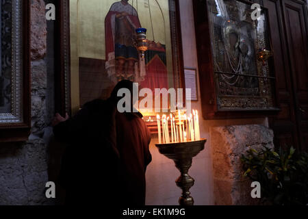 An Eastern Orthodox devotee visiting the Russian Church of Saint Alexander Nevsky in the Christian quarter old city East Jerusalem Israel Stock Photo