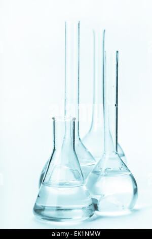 variety of glass flasks with reagents on a light background Stock Photo