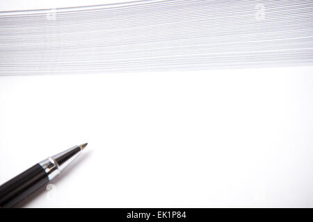 white paper with free space for sample text, envelopes in background, pen beside Stock Photo