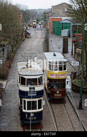 A driver on the platform of Tram 399 (Leeds 1926) as Tram 345 (Leeds 1921) passes on its way to the terminus Stock Photo